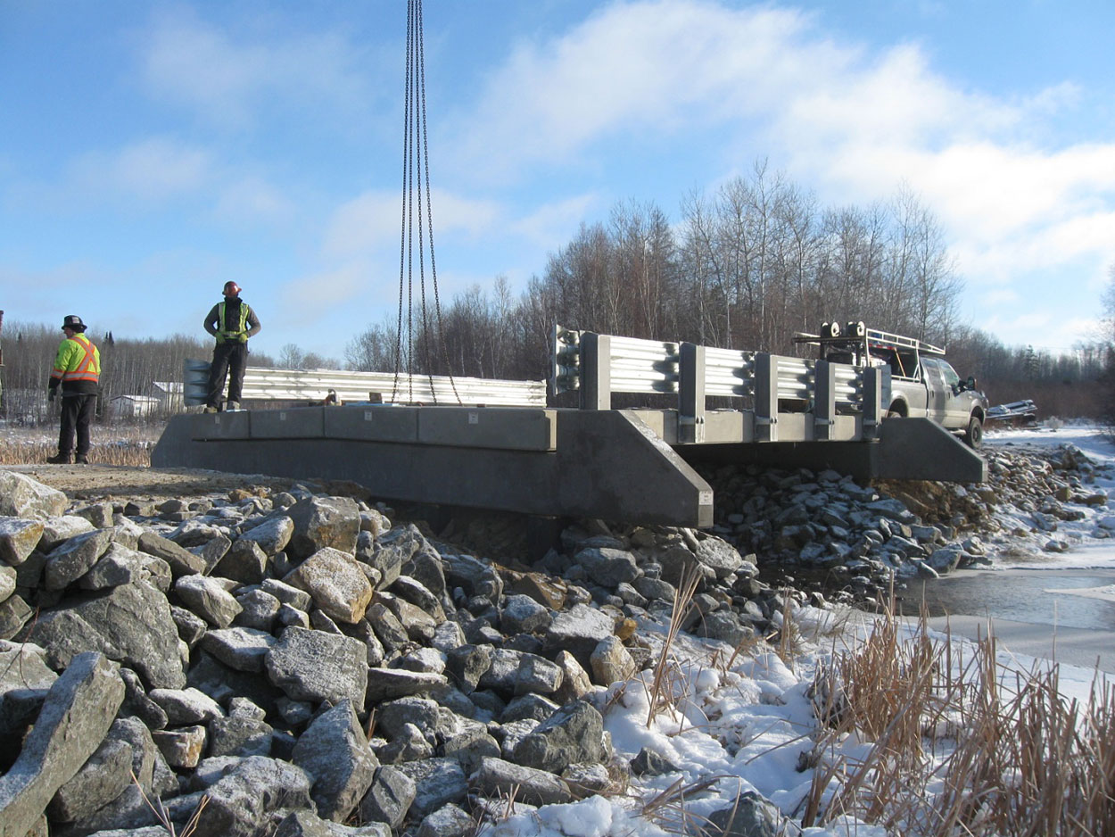 short span precast bridge including precast slab girders, precast barriers, precast caps/ballast walls and galvanized guardrail